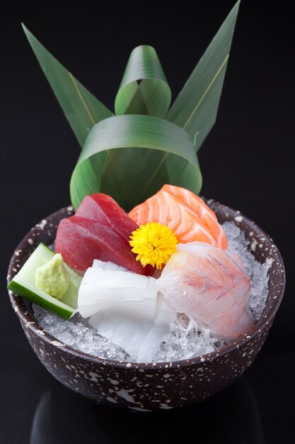 Variety of raw fish in a ceramic bowl