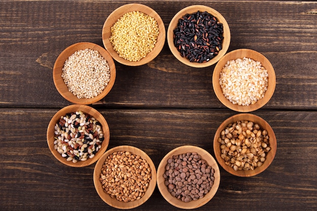 Variety of rice and grains on wooden table