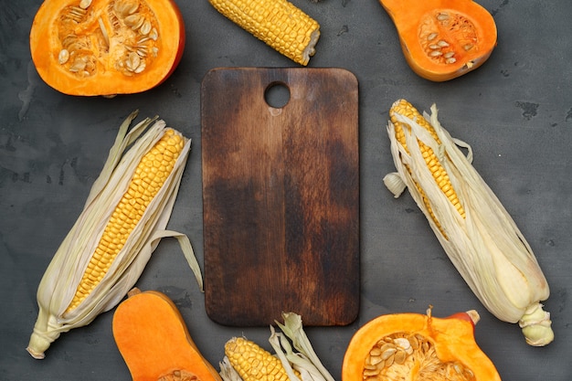 Variety of ripe vegetables including pumpkin and corn 