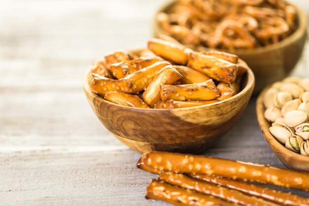 Variety of salty snacks on boow table.