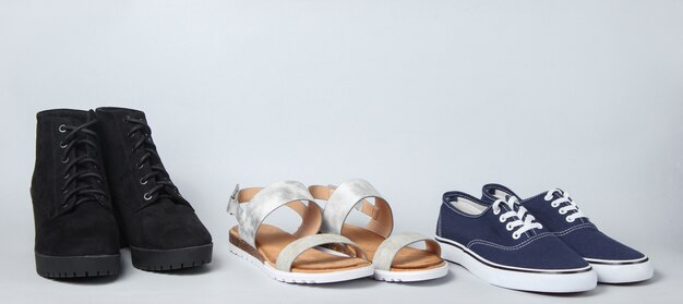 Variety of Sandals, boots, sneakers on white.