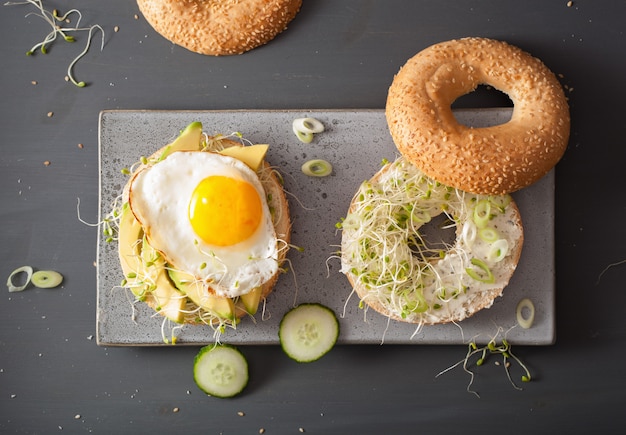 Variety of sandwiches on bagels with egg and vegetables