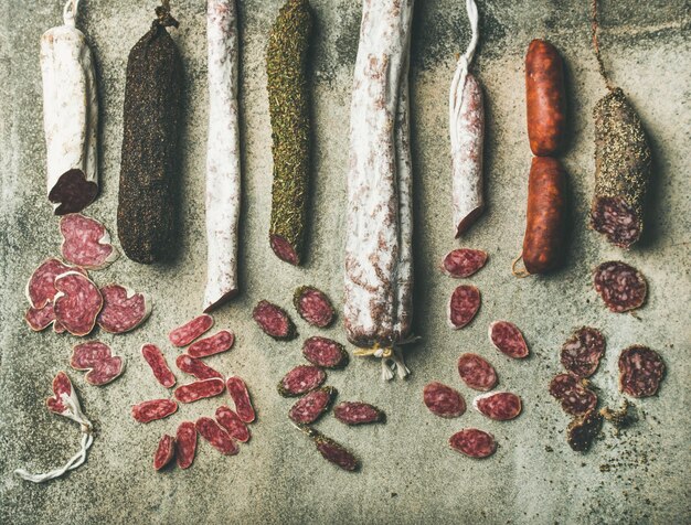 Variety of Spanish or Italian cured sausages cut in slices