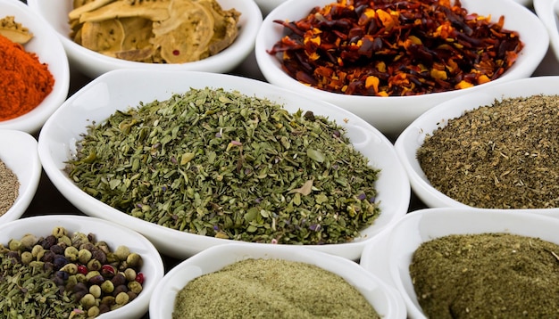 A variety of spices are displayed in bowls.