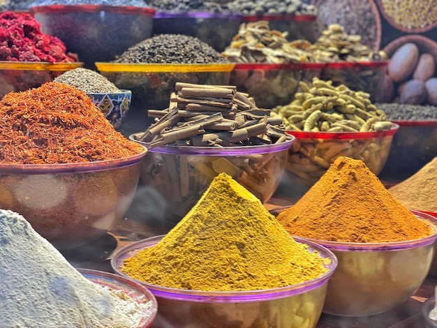 A variety of spices are displayed at a market.