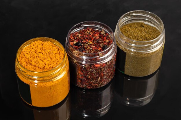 Variety of spices on a dark background in a glass bowl Enhancement of taste copy space