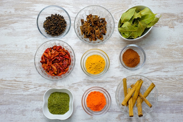 Photo variety of spices displayed in bowls