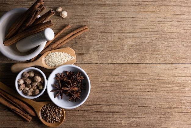 Variety of spices and natural herbs supplements health food on rustic table.