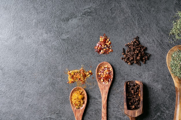 Variety of spices on wooden spoons