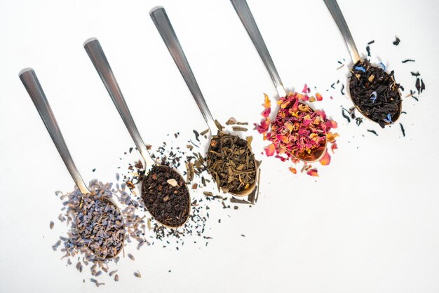 variety of tea on teaspoons white background