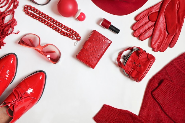 A variety of women is accessories in red on a white background