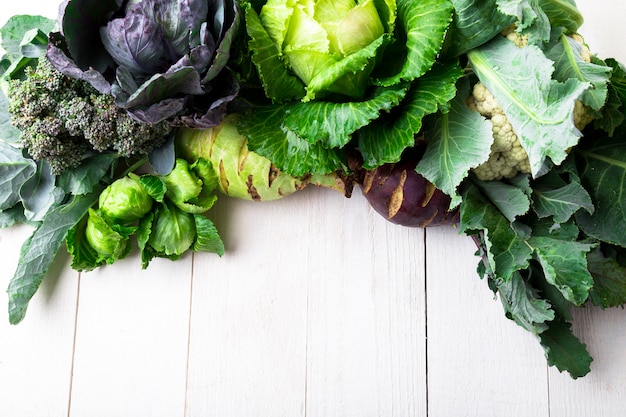 VarioAssorted of Cabbages on white wooden surface,