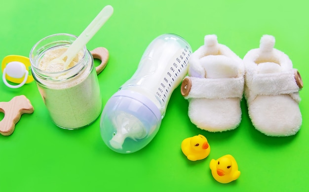 Various accessories for babies. green surface. selective focus.