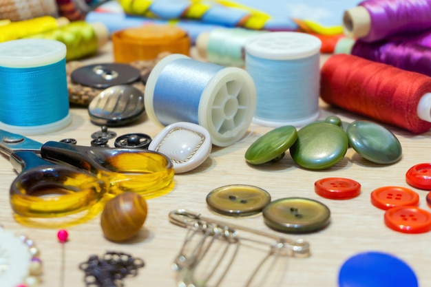 Various accessories for sewing and needlework lie on the table