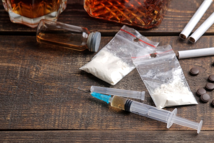 Photo various addictive drugs including alcohol, cigarettes, and drugs on a brown wooden table. drug addiction concept