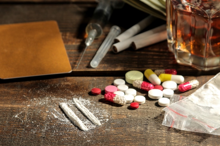 Photo various addictive drugs including alcohol, cigarettes, and drugs on a brown wooden table. drug addiction concept