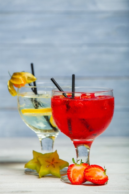 Various alcoholic cocktails on white background