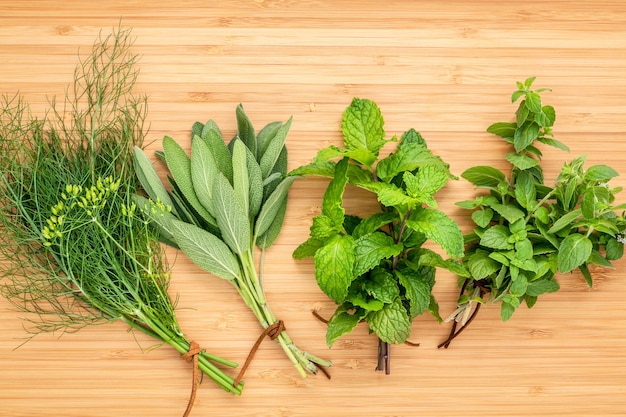 Various aromatic herbs and spices  set up on wooden background .