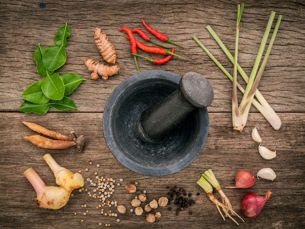 Photo various aromatic herbs and spices  set up on wooden background .