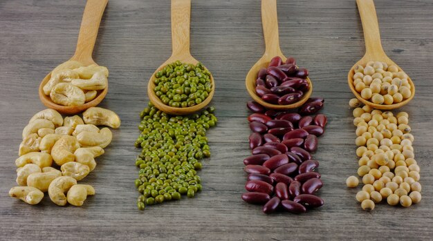 Various beans on wooden table