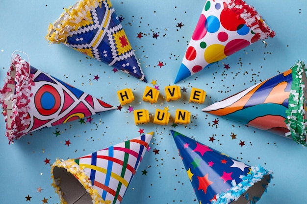 Various birthday cones with confetti on blue background