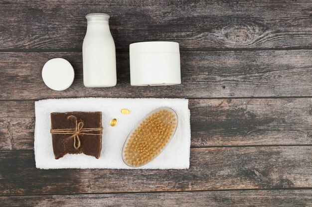 Various body care and spa products isolated on blue space. Spa composition, top view. White empty cosmetic tubes with a copy space