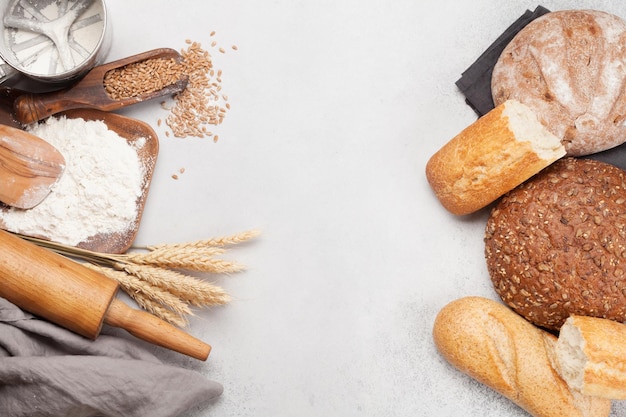 Various bread with wheat flour and cooking utensils