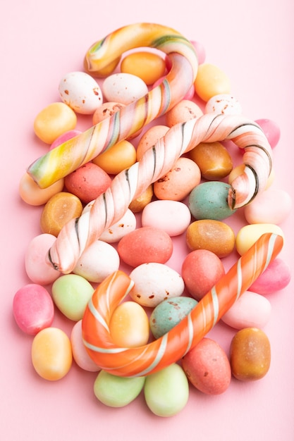 Various caramel candies on pink pastel