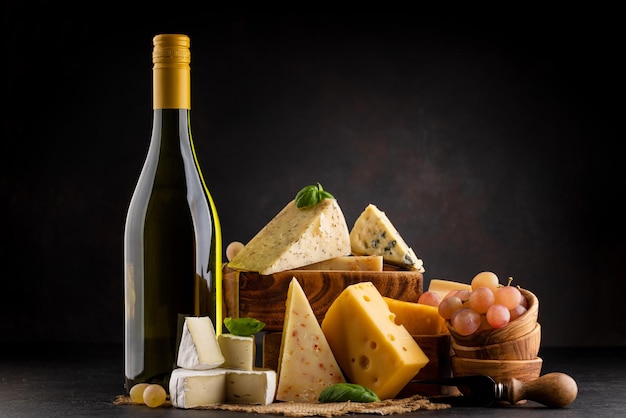 Various cheese on board and white wine