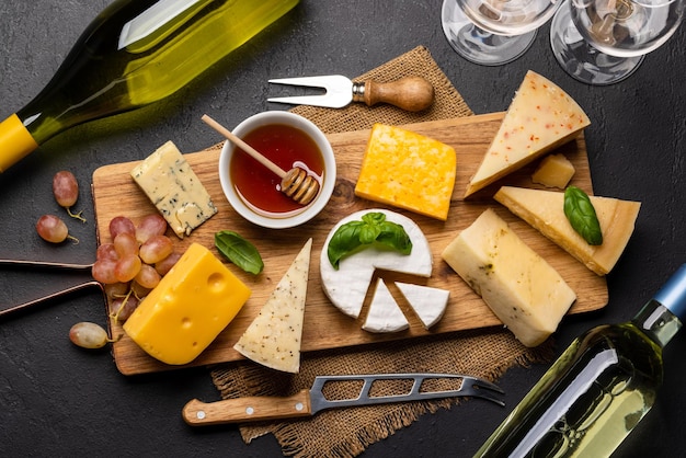 Various cheese on board and white wine