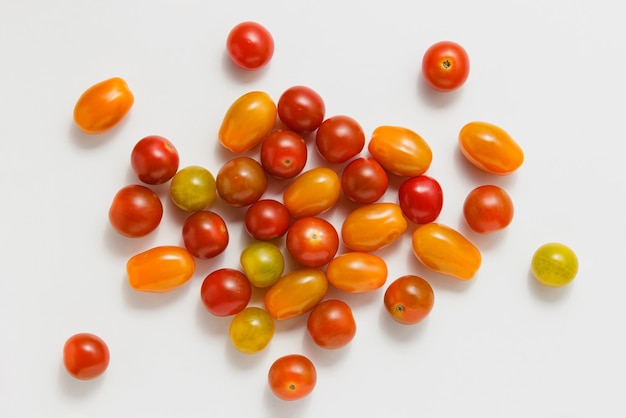 Various cherry tomatoes on white background