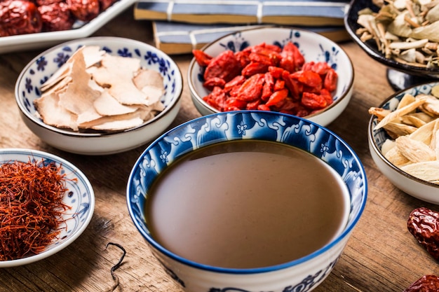 Various chinese herbal medicines made into a bowl of chinese\
medicine