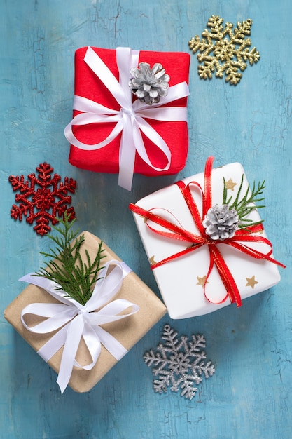 Various Christmas boxes of gifts festively decorated On a blue background.