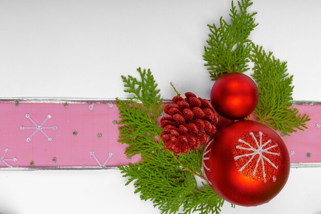 Various christmas decoration objects placed at the bottom of the image on white background