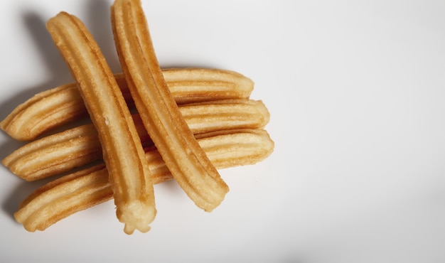 Various churros on white background