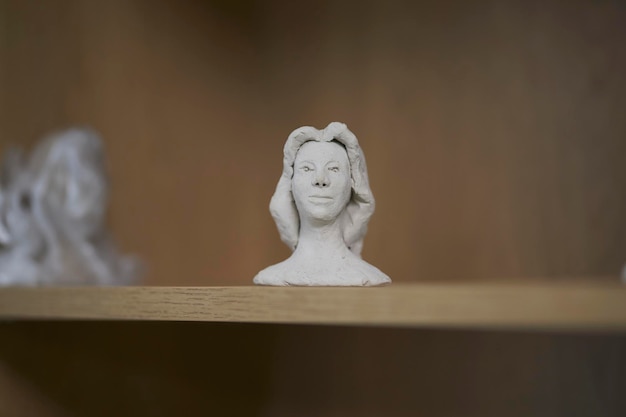 various clay figurines on a shelf at a creative master class for children