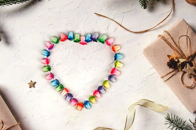 Various colored paper folded in a rabbit shape arranged into hearts on a white background