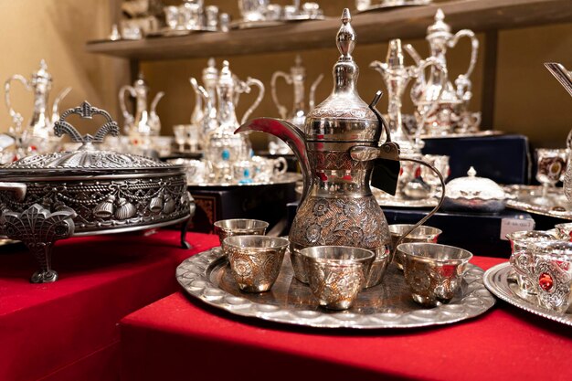 Various colorful expensive souvenirs on the counter in the store at the bazaar in city of Dubai United Arab Emirates market Souk Madinat Jumeirah UAE