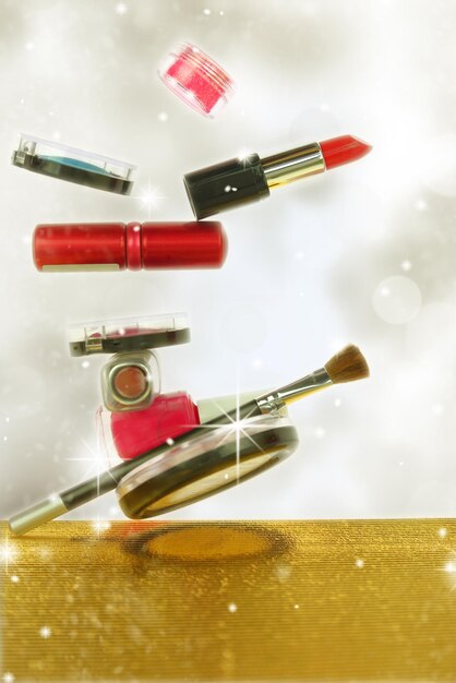 Various cosmetics in a glittery background