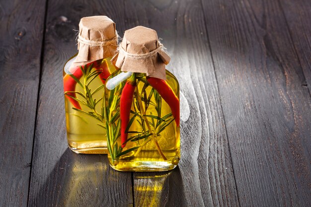 Various culinary oil in glass vial over wooden surface