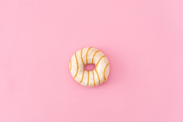 Various decorated doughnuts in motion falling on pink background. Sweet and colourful doughnuts falling or flying in motion. 