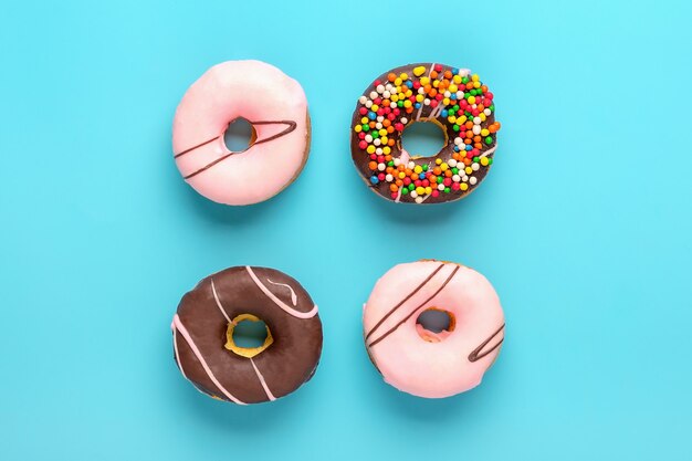 Various decorated with colorful sprinkles donuts isolated