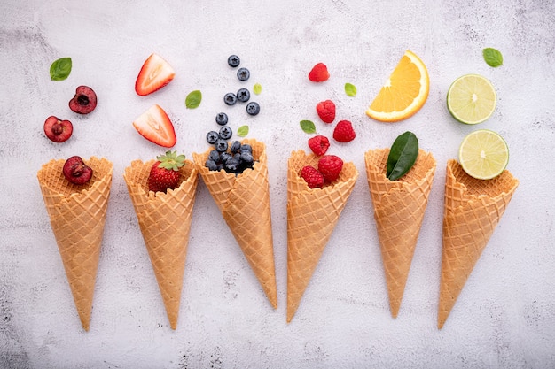 Various delicious fruits in waffle cones