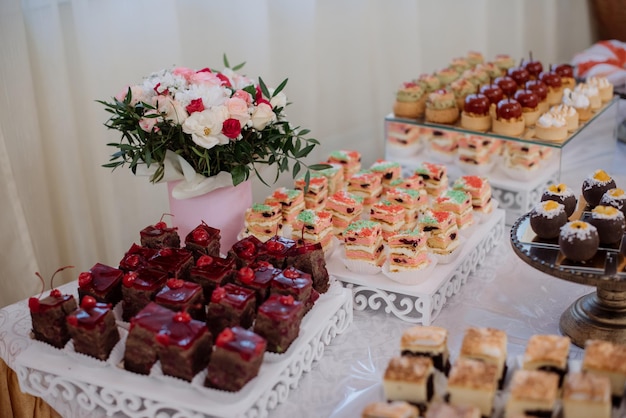 Various desserts and cake on the buffet table at the wedding