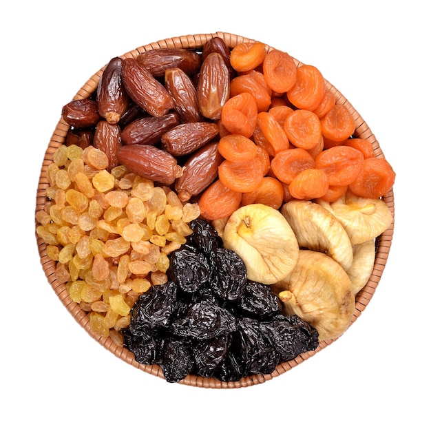 Various dried fruits in bowl on a white background