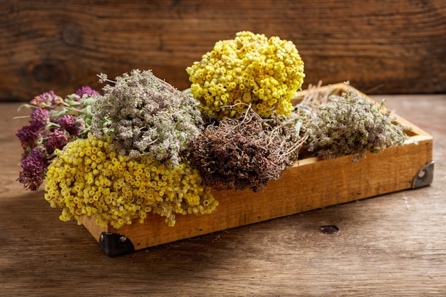 Various dried herbs on wooden table