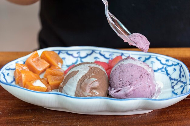 Various flavors of ice cream with toppings on the table