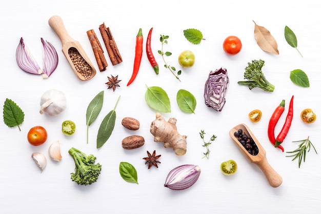 Various fresh vegetables and herbs on white background