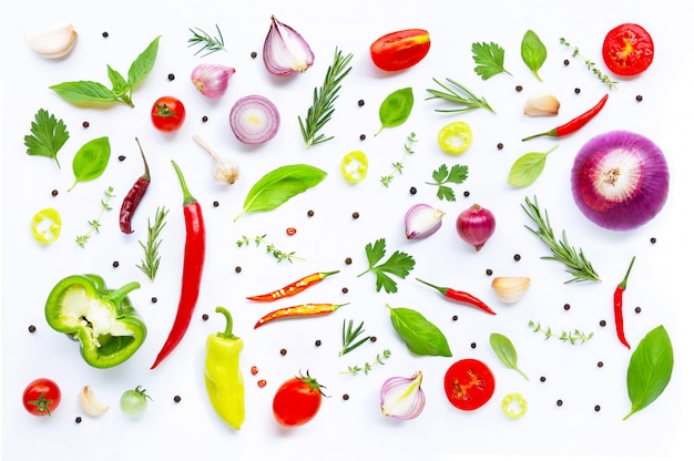 Various fresh vegetables and herbs on white background. 