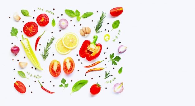 Various fresh vegetables and herbs on over white background.